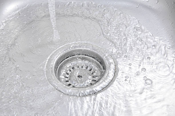 istock Water Flowing Down To The Hole In A Kitchen Sink 465999932