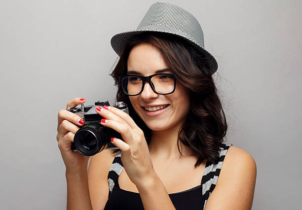 istock Beautiful girl in a hat with camera. 465999998