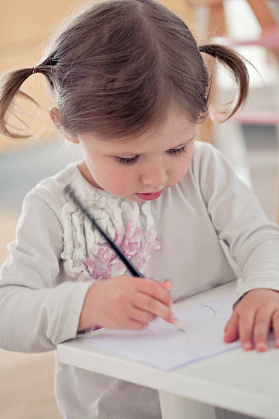 istock Little Girl Writing with Pen. 466005081