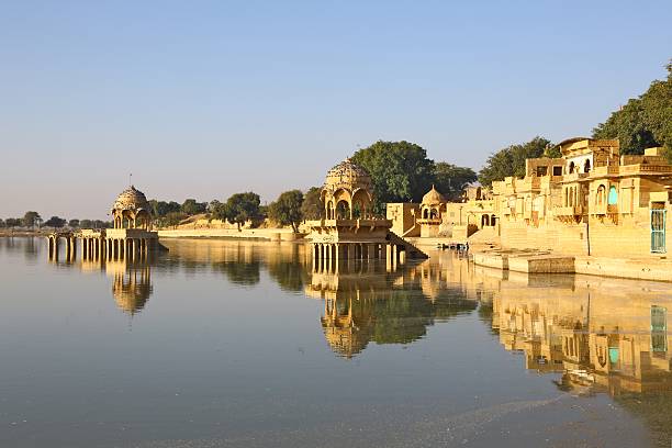 Hinduist temples on lake of Jaisalmer, India Hinduist temples on lake of Jaisalmer in warm light of early morning, India jaisalmer stock pictures, royalty-free photos & images