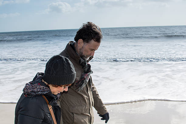 istock Man and wife walking along the shore 466006692