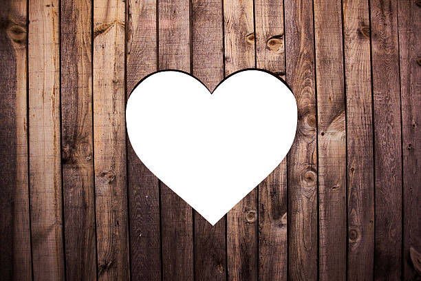 Cut out heart shape on old wood background 