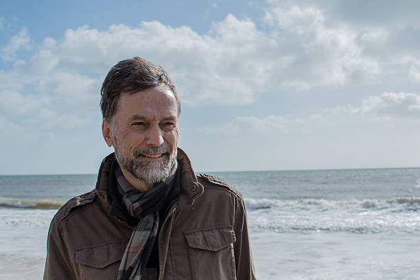 istock Man standing by the sea 466008234