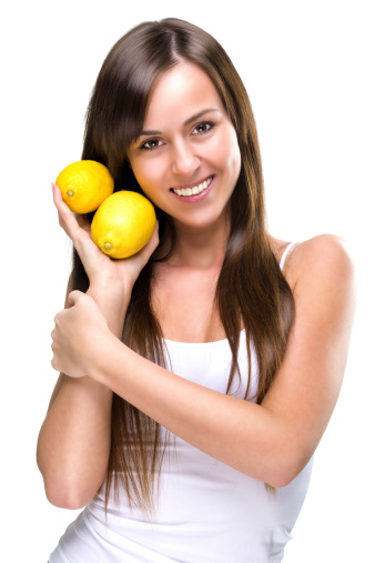 Healthy lifestyle - Beautiful pretty woman is holding two lemons