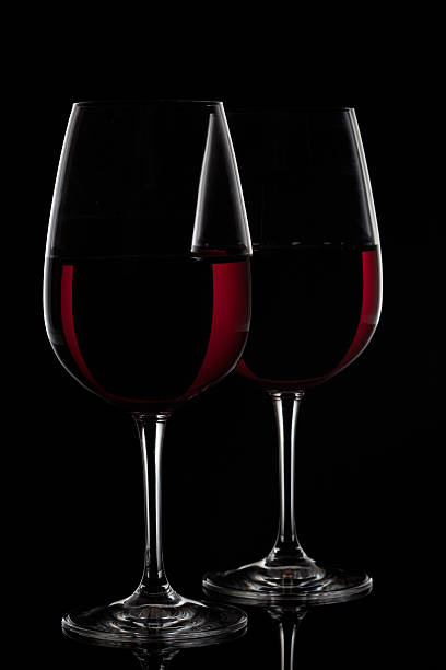 istock Two glasses with red wine on black background 466011063