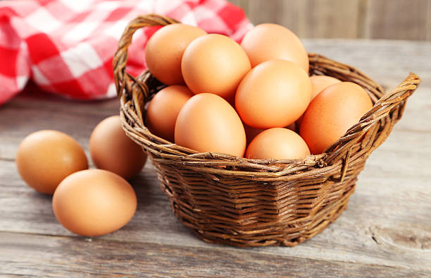 istock Chicken eggs in basket on grey wooden background 466012226