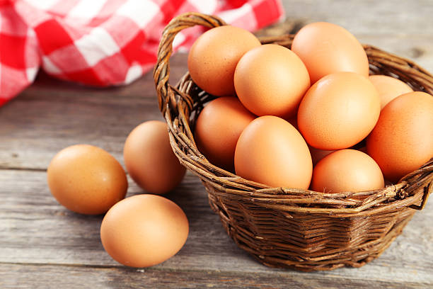 istock Chicken eggs in basket on grey wooden background 466012232