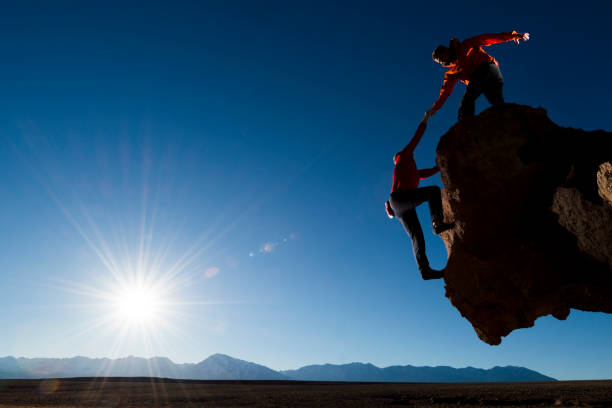gotcha Friends rock climbing, helping each other  steep photos stock pictures, royalty-free photos & images