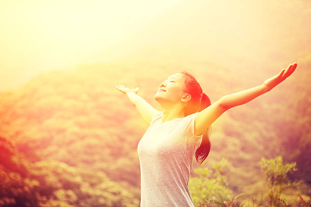 istock cheering hiking woman open arms at mountain peak 466013166