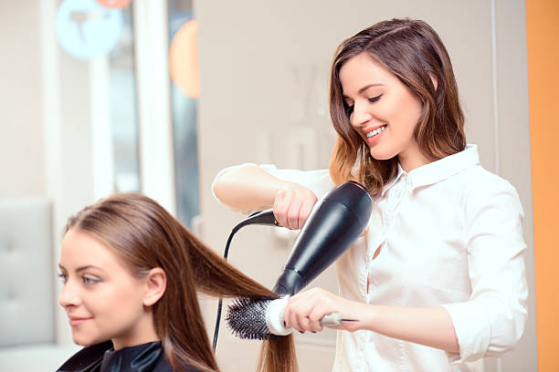 istock Woman working on another woman's hair 466014124