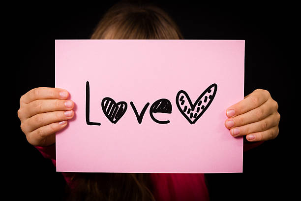 istock Child holding Love sign 466017302
