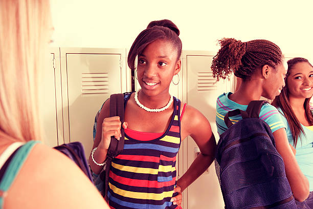 istock Education:  Teenage girlfriends talk in school hall. 466017425