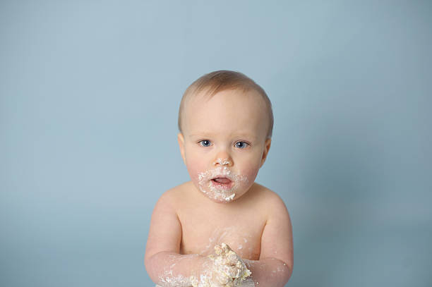 istock Baby Boy Eating Birthday Cake 466017775