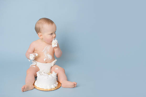 istock Baby Boy Eating Birthday Cake 466017909