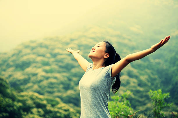 istock cheering hiking woman open arms at mountain peak 466018254