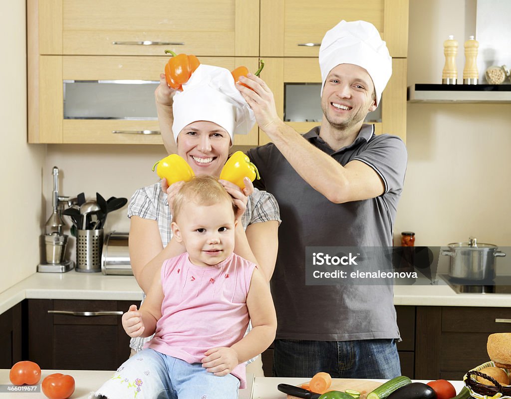 family cooks in the kitchen (real family) Adult Stock Photo