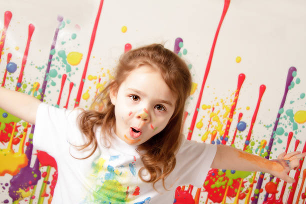 istock Happy little girl covered in paint 466023264