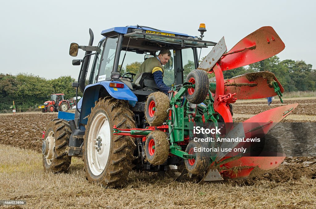 Ploughing Championship, Conventional Class Basingstoke, UK - October 12, 2014:   A competitor in the one way ploughing  reversible class on the second day of the British National Ploughing Championships organised by the Society of Ploughmen. Accredited photographer 2015 Stock Photo