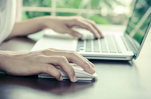 istock Close-up of a person using a laptop and mouse 466024206