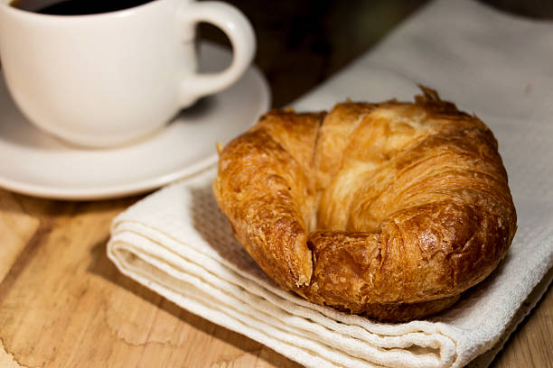 istock coffee and croissant on wooden table 466025001