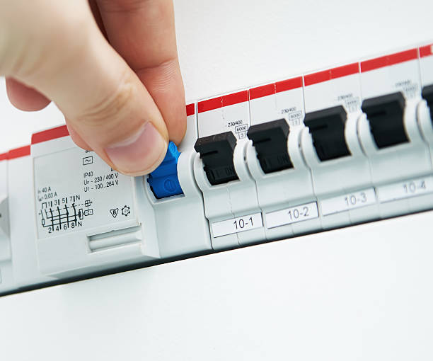 istock Man flipping blue switch among black switches 466025035