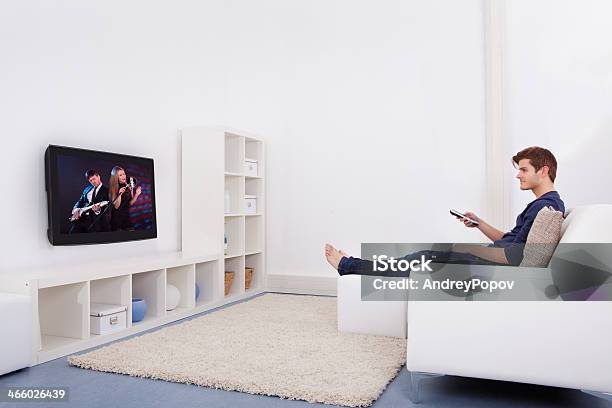 Man Watching Television Stock Photo - Download Image Now - Side View, Surrounding Wall, Sofa