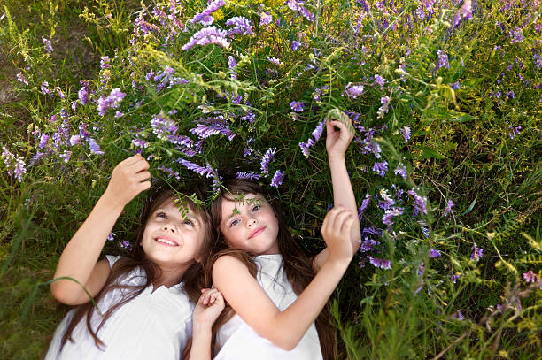 istock Portrait of two young girlfriends with flowers 466028802