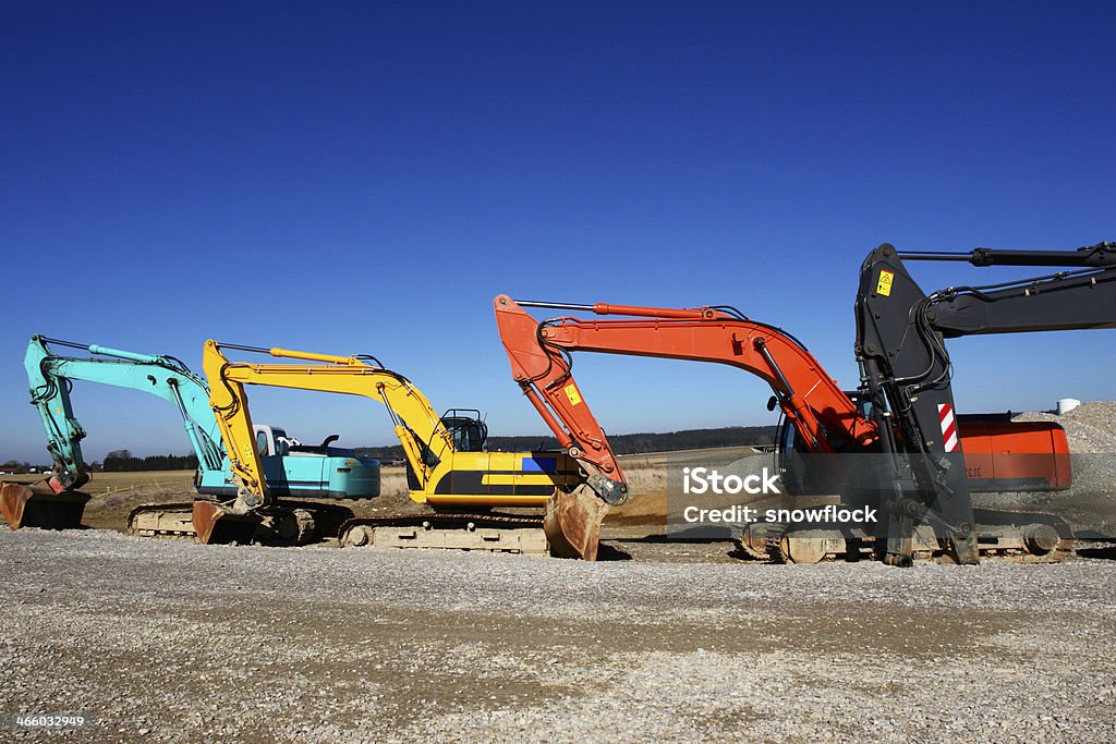excavator excavator on a building site on a sunny day Agricultural Machinery Stock Photo