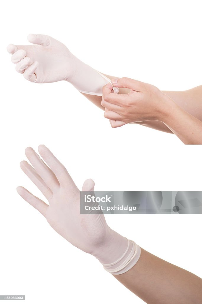 Doctor wears sterile latex gloves The doctor wears sterile latex gloves. Adult Stock Photo