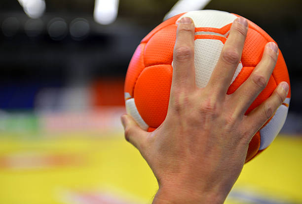 istock Hand holding an orange handball 466034699