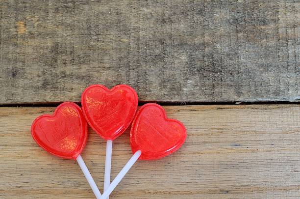 istock Red heart shaped lollipops, set in floral design 466034842