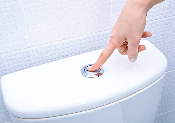 finger pushing button and flushing toilet finger pushing button and flushing toilet public restroom photos stock pictures, royalty-free photos & images