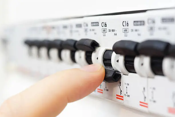 Photo of Finger flipping switch on fusebox