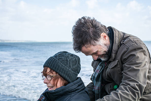 istock Husband and wife laughing at the beach 466037354
