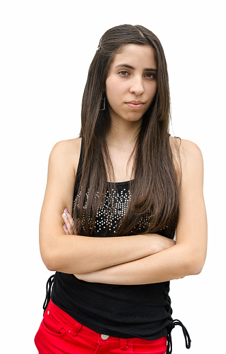 A very serious teenage girl with arms cross looking at the camera