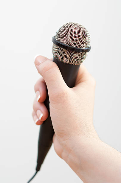 istock Woman holding a black microphone 466038272