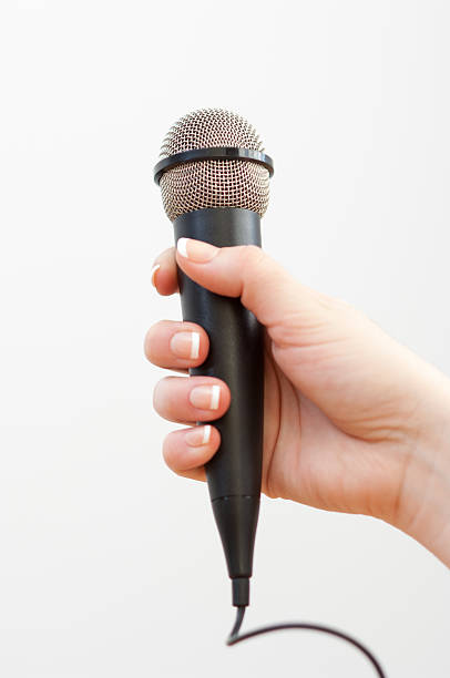 istock Woman holding a black microphone 466038274