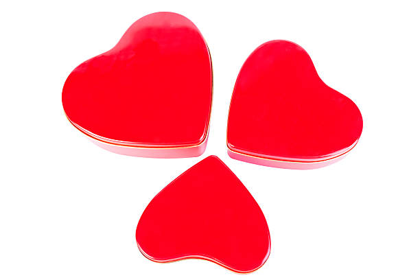 istock Three heart-shaped red tins against a white background 466038681