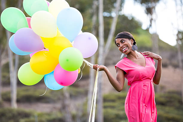 Happy young woman with colorful balloons