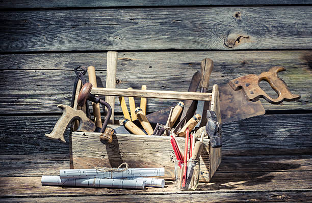 istock Hammer, saw and paper scheme in the carpentry toolbox 466044334