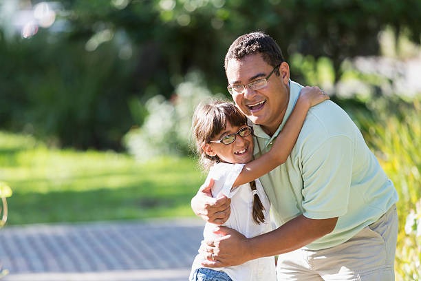 istock Hispanic father and daughter hugging 466045969
