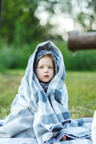 istock Little boy wrapped in a blanket 466048420