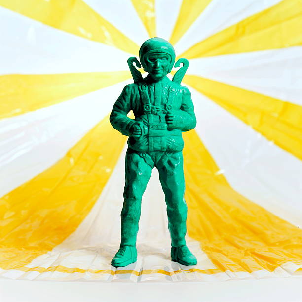 Green Man With Yellow and White Parachute stock photo