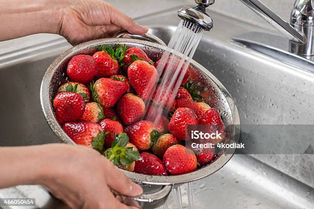 A Silver Colander Full Of Strawberries Being Rinsed Stock Photo - Download Image Now