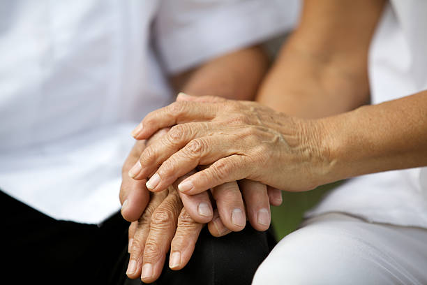 istock Elderly couple holding hands 466051095