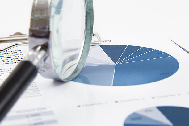istock magnifying glass on the business report 466051201