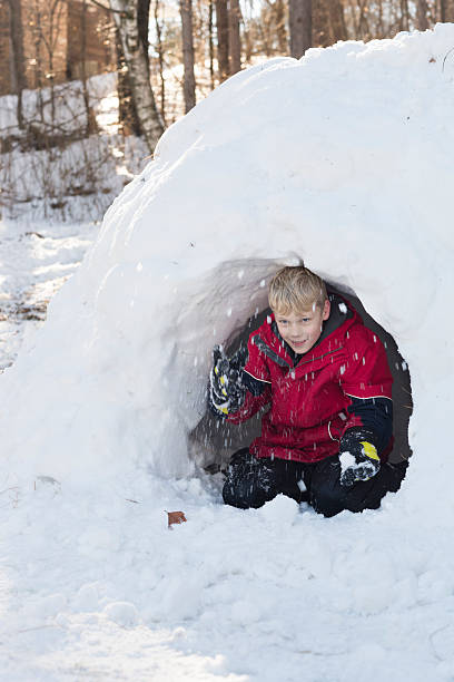 istock Boy plays in snow fort 466054629