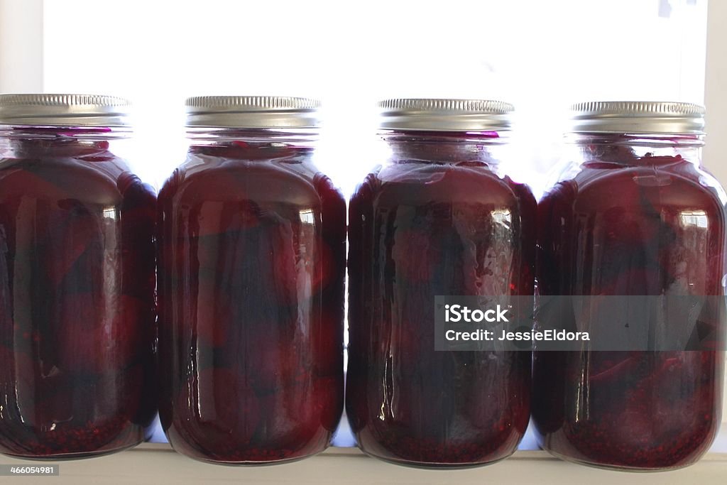 Jars of beet pickles Beets on a shelf, over white. Beet Stock Photo