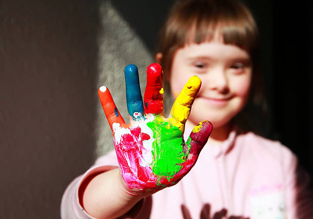 istock Young girl smiling and showing painted hands 466058646