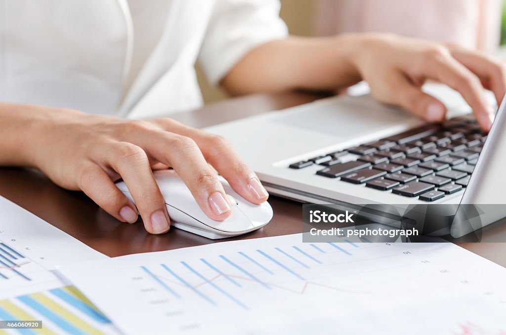 Working with computer Woman using a mouse working on the computer 2015 Stock Photo